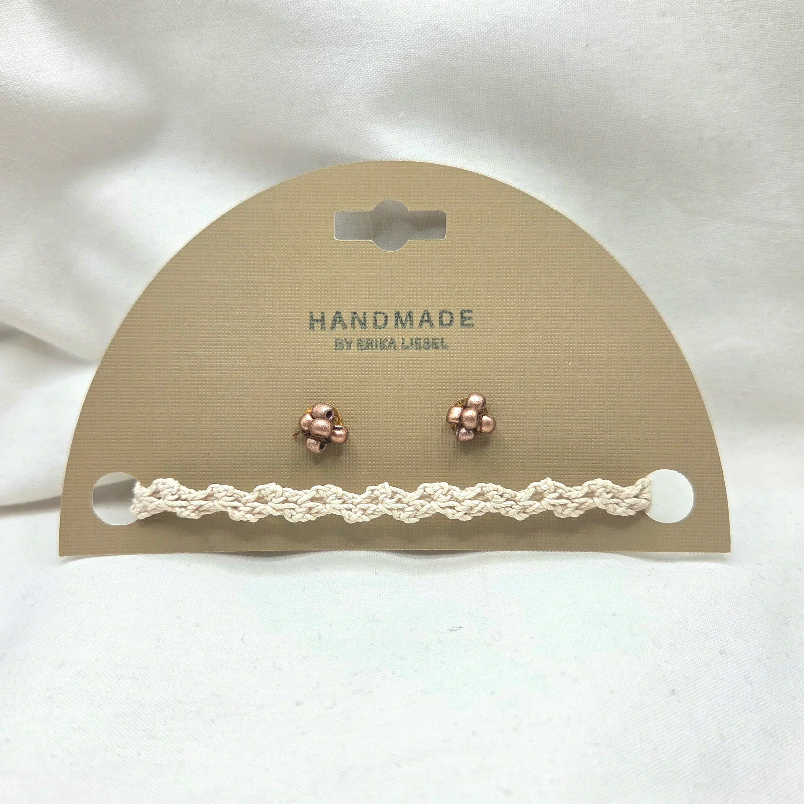 Handmade crochet bracelet and rose gold stud earrings on display card, cozy artisan jewelry set