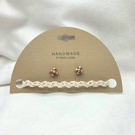 Handmade crochet bracelet and rose gold stud earrings on display card, cozy artisan jewelry set