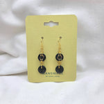 Handmade black button dangle earrings with gold hooks on yellow card, cozy crochet gift style