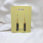 Handmade coconut shell earrings with gold hooks on pale yellow card, eco-friendly boho jewelry
