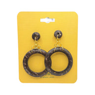 Handmade coconut shell hoop earrings with gold accents on yellow display card