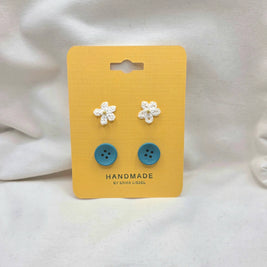 Handmade crochet flower and blue button earrings on yellow card, cozy craft gift set