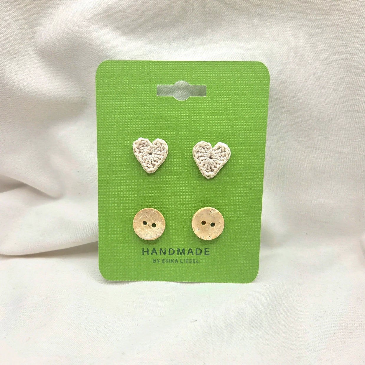 Handmade crochet heart and coconut buttons on green card, cozy craft supplies for DIY projects