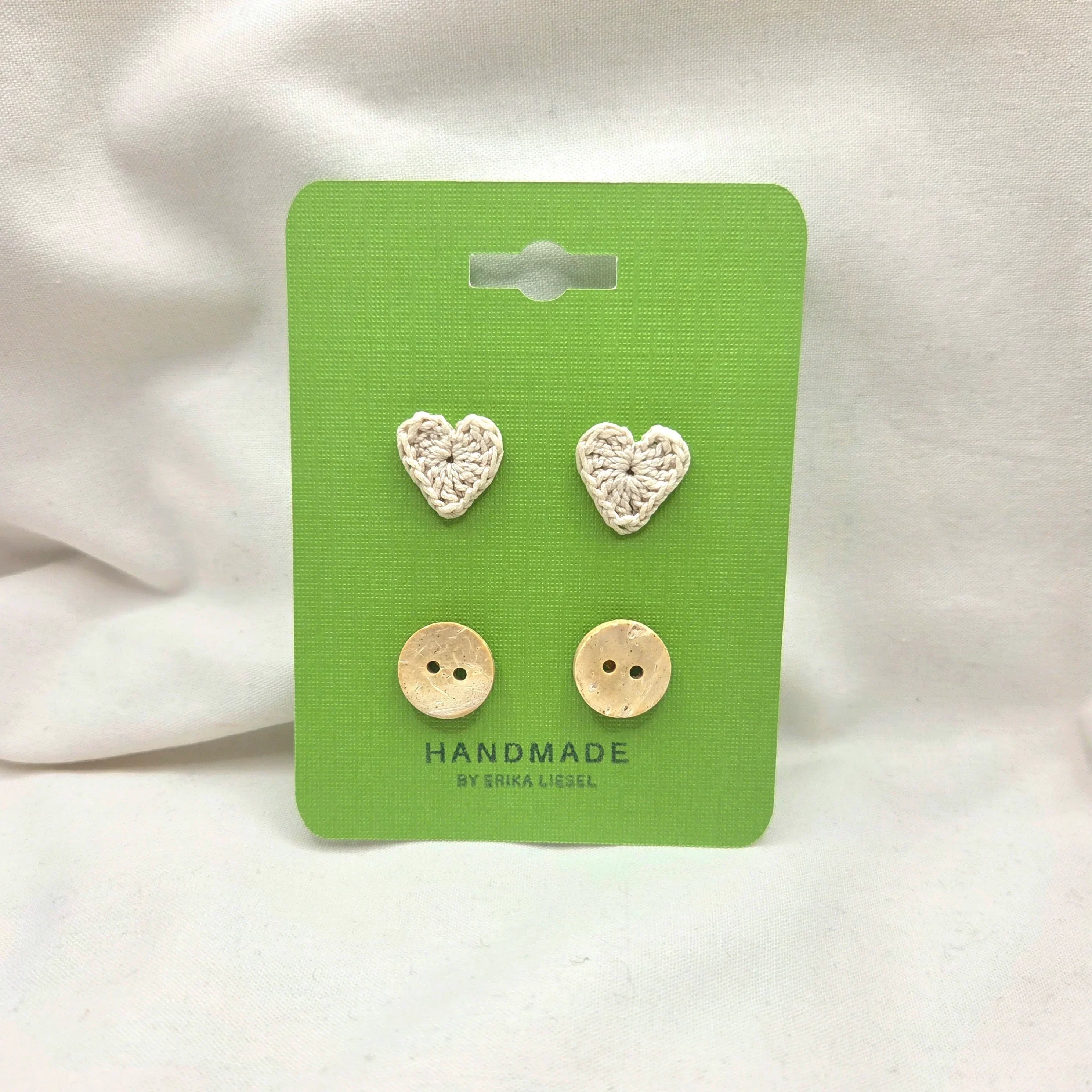 Handmade crochet heart and coconut buttons on green card, cozy craft supplies for DIY projects