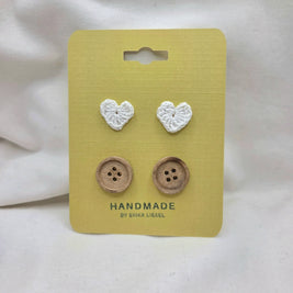 Handmade crochet heart and wooden buttons on yellow card, cozy craft supplies for DIY projects