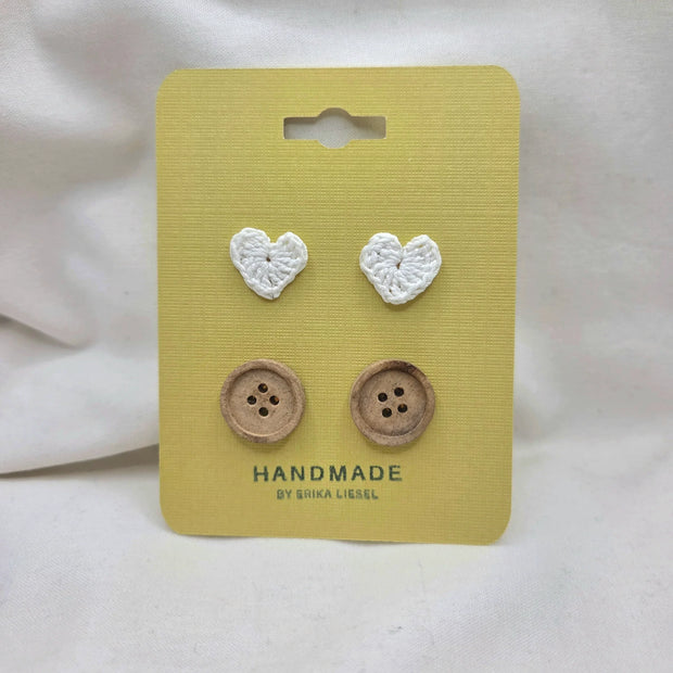 Handmade crochet heart and wooden buttons on yellow card, cozy craft supplies