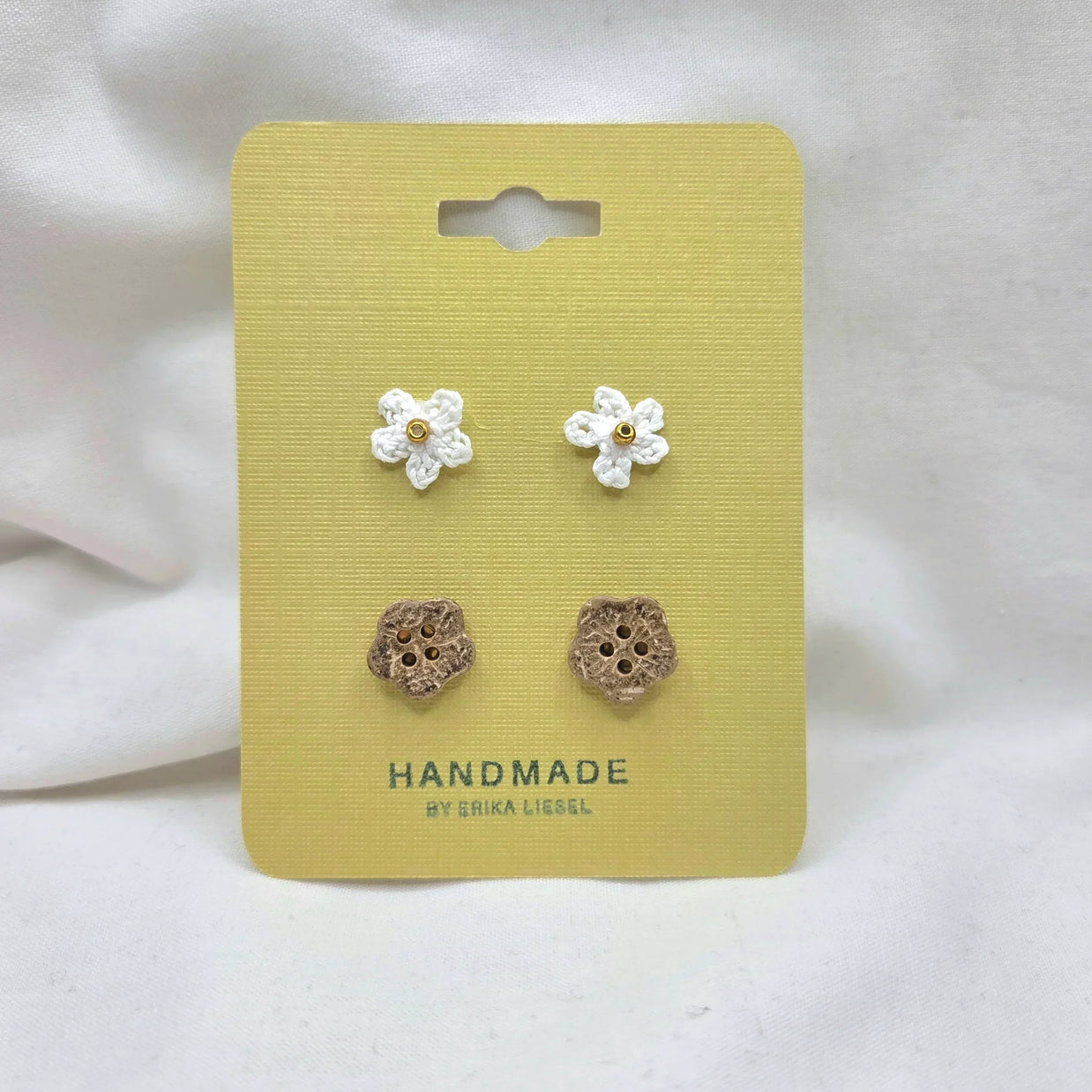 Handmade crochet flower and wooden buttons on yellow card, cozy craft supplies for DIY projects