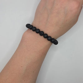 Black lava stone bracelet on wrist, minimalist and elegant design for everyday wear