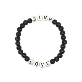 A beaded stretch bracelet on a plain white background, featuring black round beads and white letter beads spelling out 'HATE' on one side and 'LOVE' on the other.