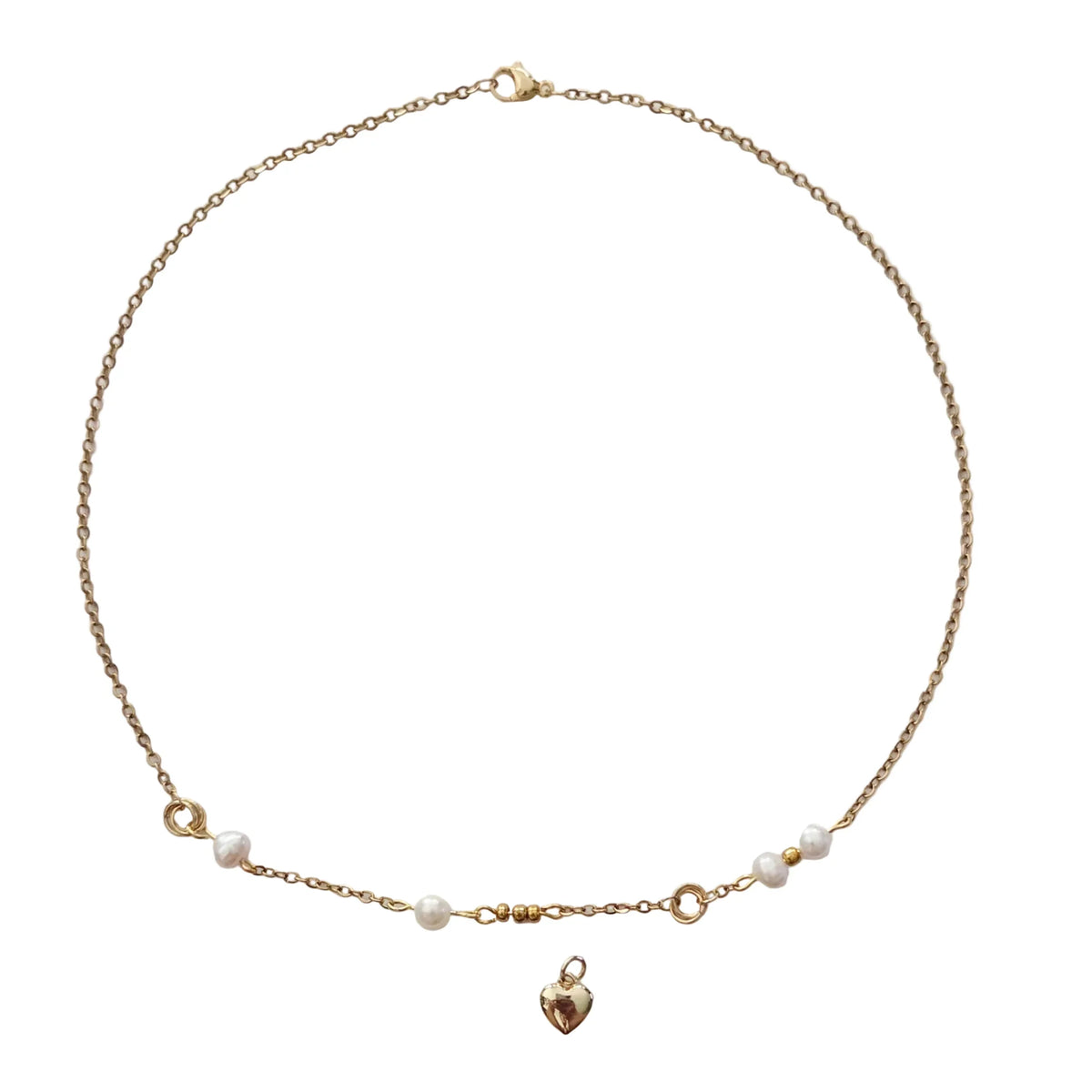 A delicate gold chain necklace with small white pearl beads and a small gold heart pendant, displayed on a clean white background.