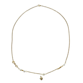 A delicate gold chain necklace featuring small white pearl beads and a small gold heart pendant, displayed on a white background.