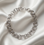 Elegant silver chain-link bracelet on soft satin fabric, perfect for cozy handmade gifts