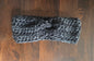 Handmade chunky knit charcoal headband on dark wooden table