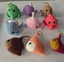 Colorful crochet sea creature keychains arranged on a white surface