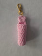 Pink crochet keychain holder with gold clasp on light background