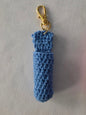 Blue crocheted keychain with a gold clasp on a light gray background
