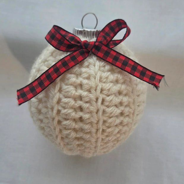 Crocheted cream yarn Christmas ornament with red plaid ribbon bow