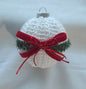 White crochet Christmas ornament with pine garnish and red velvet ribbon bow