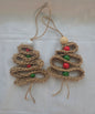 Handmade jute Christmas tree ornaments with red and green beads on white background