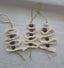 Handmade macrame Christmas tree ornament with black beads on white fabric