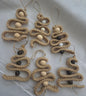 Handmade jute Christmas tree ornaments with wooden beads on white fabric