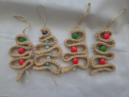 Handmade crochet Christmas tree ornaments with red, green, and blue wooden beads on white background