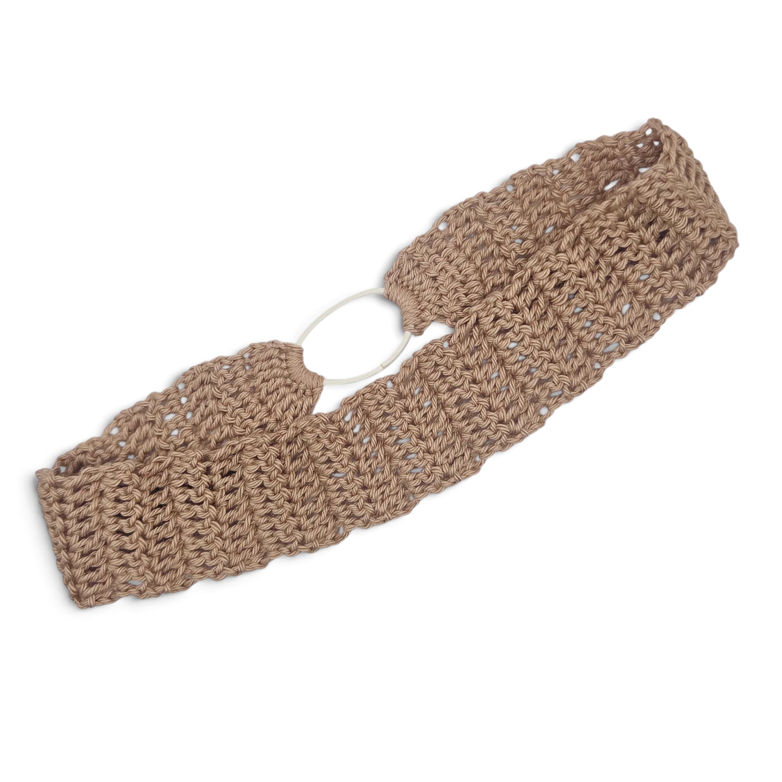 Handmade crochet headband in soft beige, featuring open stitch pattern and white elastic band for comfort.