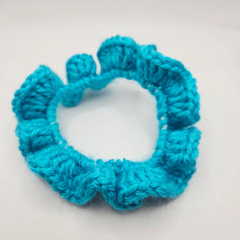 Handmade turquoise crochet scrunchie on white background, cozy gift by Erika Liesel