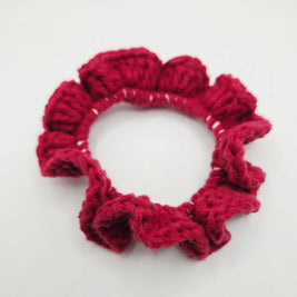 Handmade red crochet hair scrunchie with ruffled texture, cozy and creative accessory