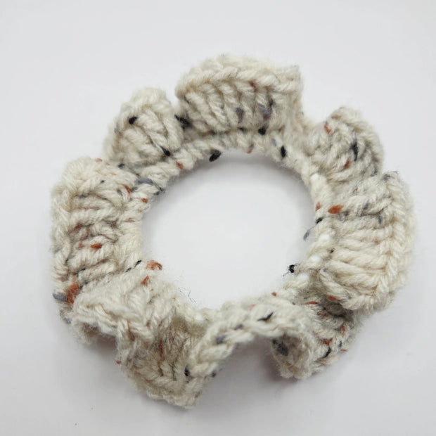 Handmade crochet scrunchie in cream yarn with speckles, cozy accessory by Erika Liesel