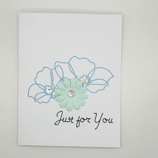 Handmade greeting card with pastel blue flower, sequin accents, and 'Just for You' text