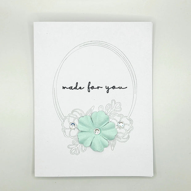 Handmade greeting card with mint green flower, rhinestones, and 'made for you' text on white