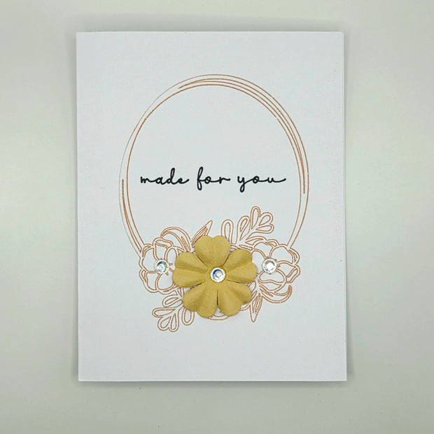 Handmade greeting card with yellow flower, jewels, and 'made for you' text on white background