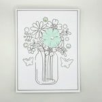 Handmade floral card with mint paper flower, glitter outlines, and rhinestone accents in a mason jar design