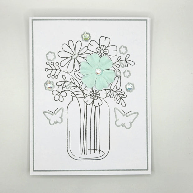 Handmade card with mason jar flower bouquet, pastel flower, rhinestones, and butterfly accents
