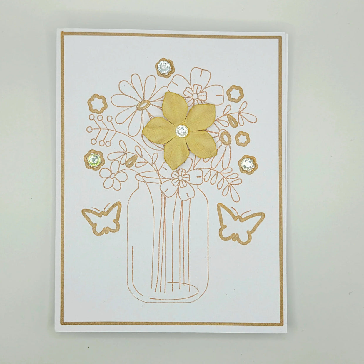 Handmade floral greeting card with yellow flower, butterfly accents, and crystal embellishments