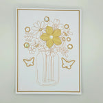 Handmade floral card with gold glitter flowers, butterflies, and rhinestones in a mason jar design