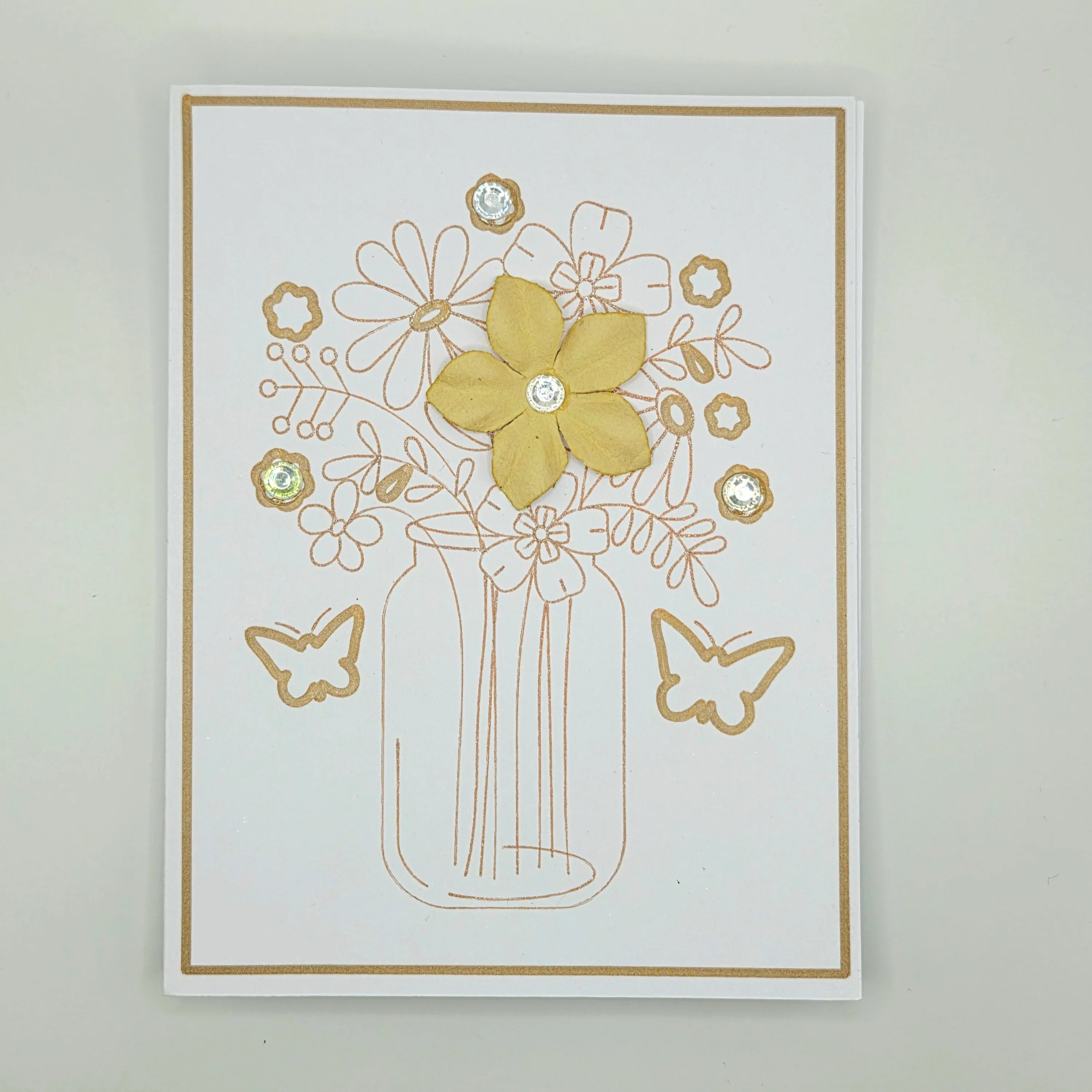 Handmade floral greeting card with yellow flower, butterfly accents, and crystal embellishments