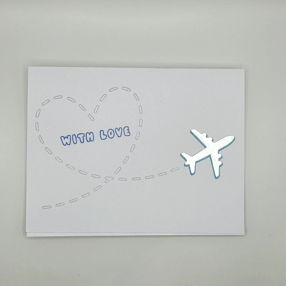 Handmade card with airplane flying into heart shape, 'WITH LOVE' text, perfect for travel-themed gifts