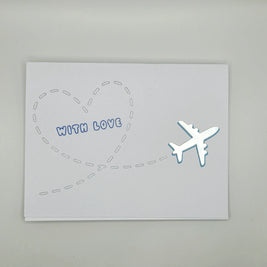 Handmade greeting card with silver airplane and heart-shaped flight path, text 'With Love'.