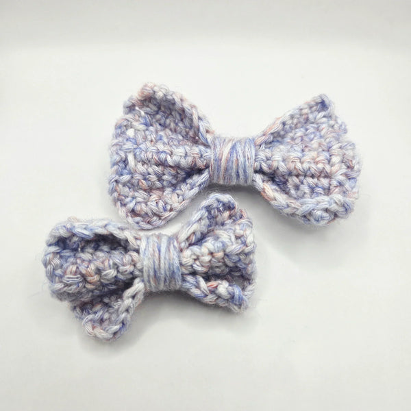 Handmade crochet bows in soft pastel yarn, perfect for cozy gifts and creative styling.