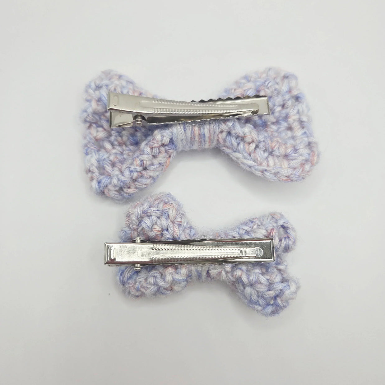 Handmade crochet hair clips in pastel hues, perfect for cozy, creative styling