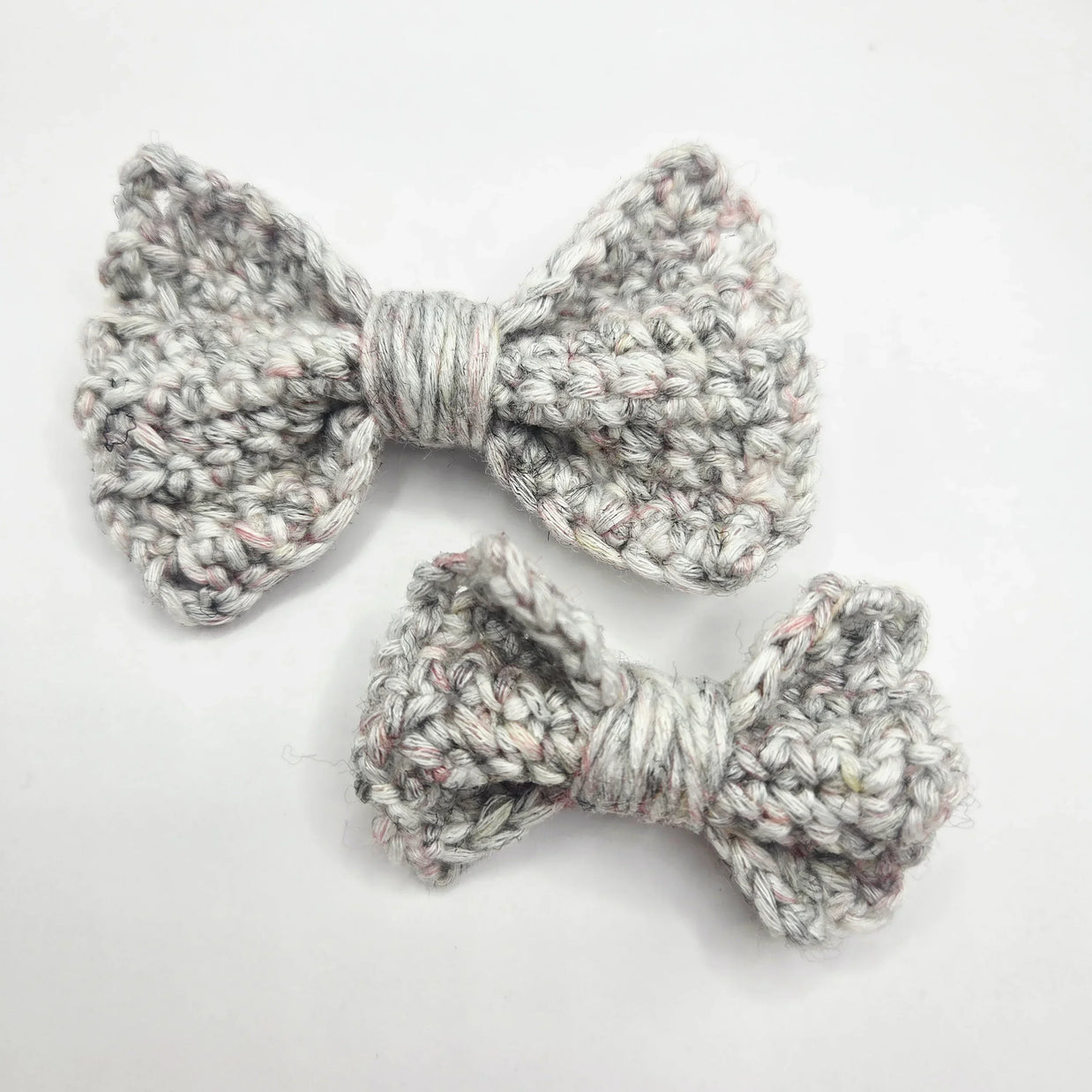Handmade crochet bows in soft gray yarn, perfect for cozy, creative gifts.