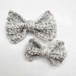 Handmade crochet bows in soft gray yarn, perfect for cozy, creative gifts.