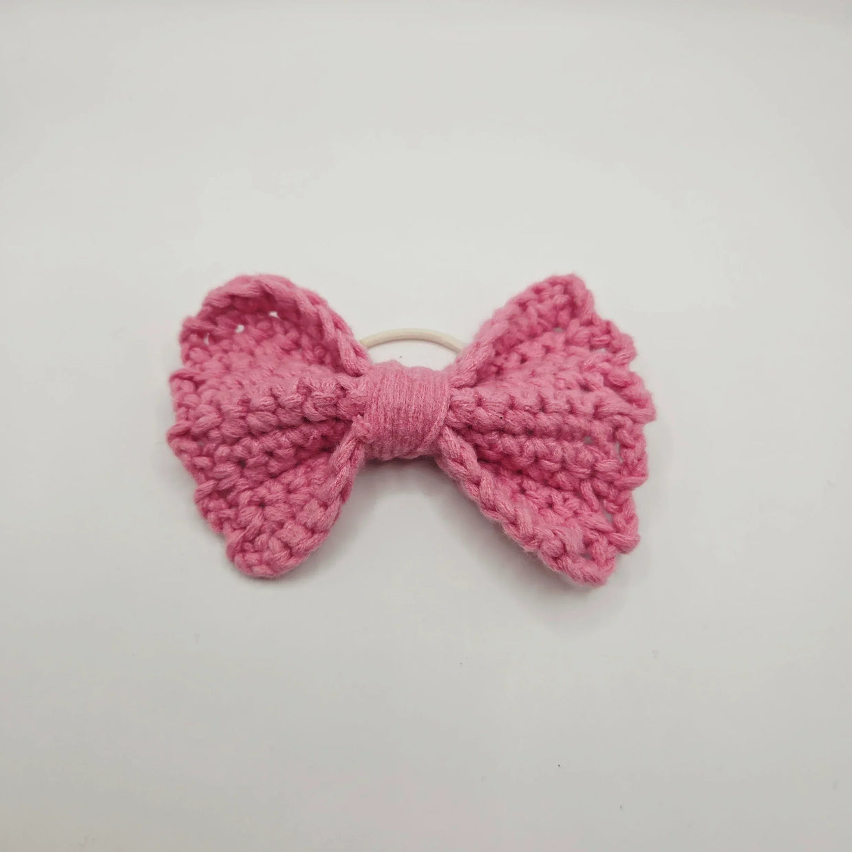 Handmade pink crochet bow hair tie for cozy, creative styling