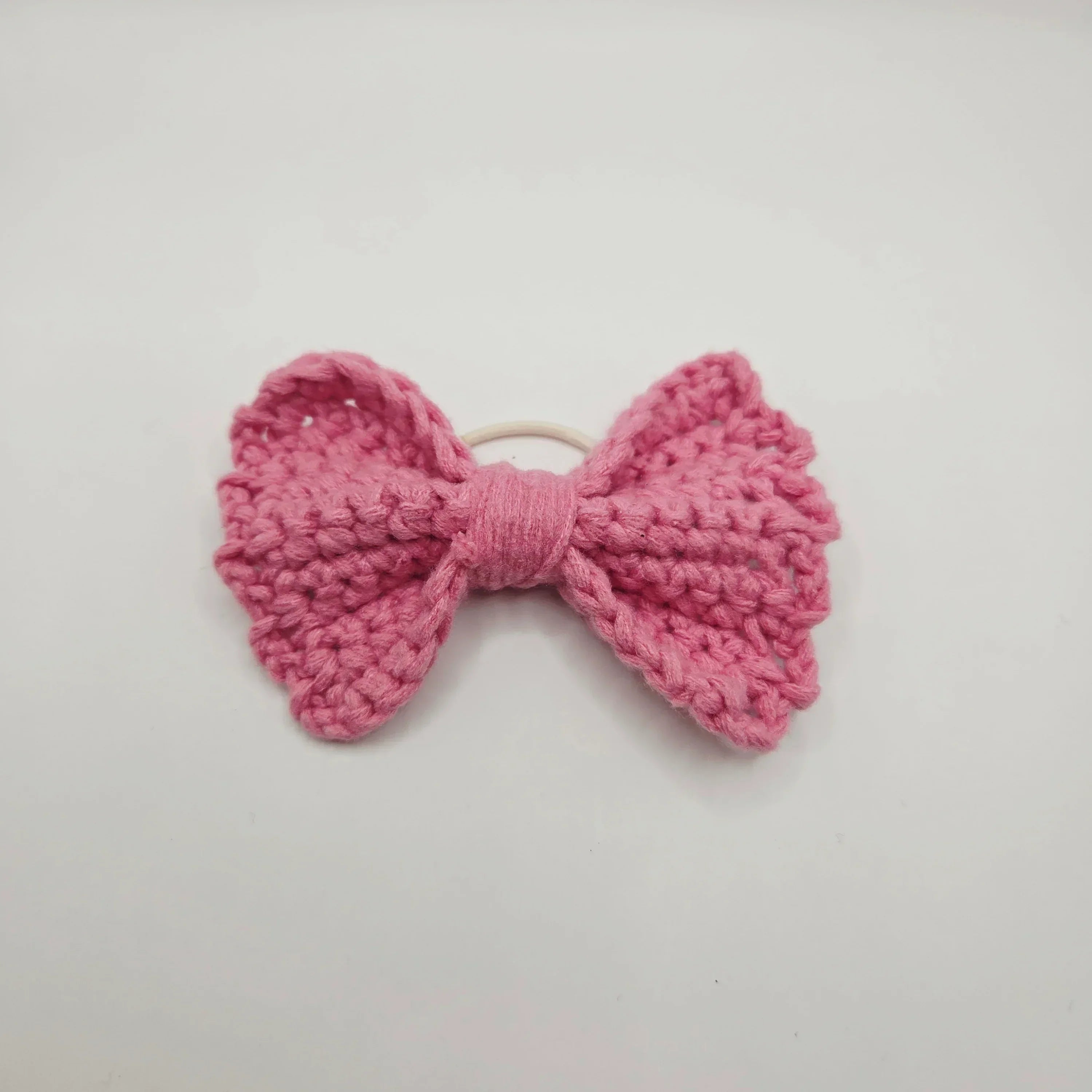 Handmade pink crochet bow hair tie for cozy, creative styling