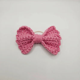 Handmade pink crochet bow hair tie for cozy, creative styling
