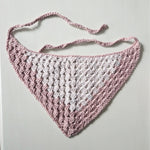Handmade crochet baby bib in soft pink and white, cozy and breathable design for infants