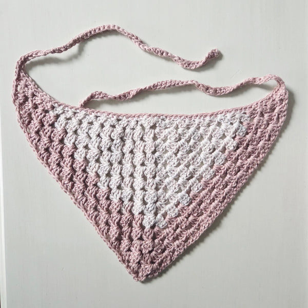 Handmade crochet triangle scarf in pink and white, perfect for cozy, creative gifting.
