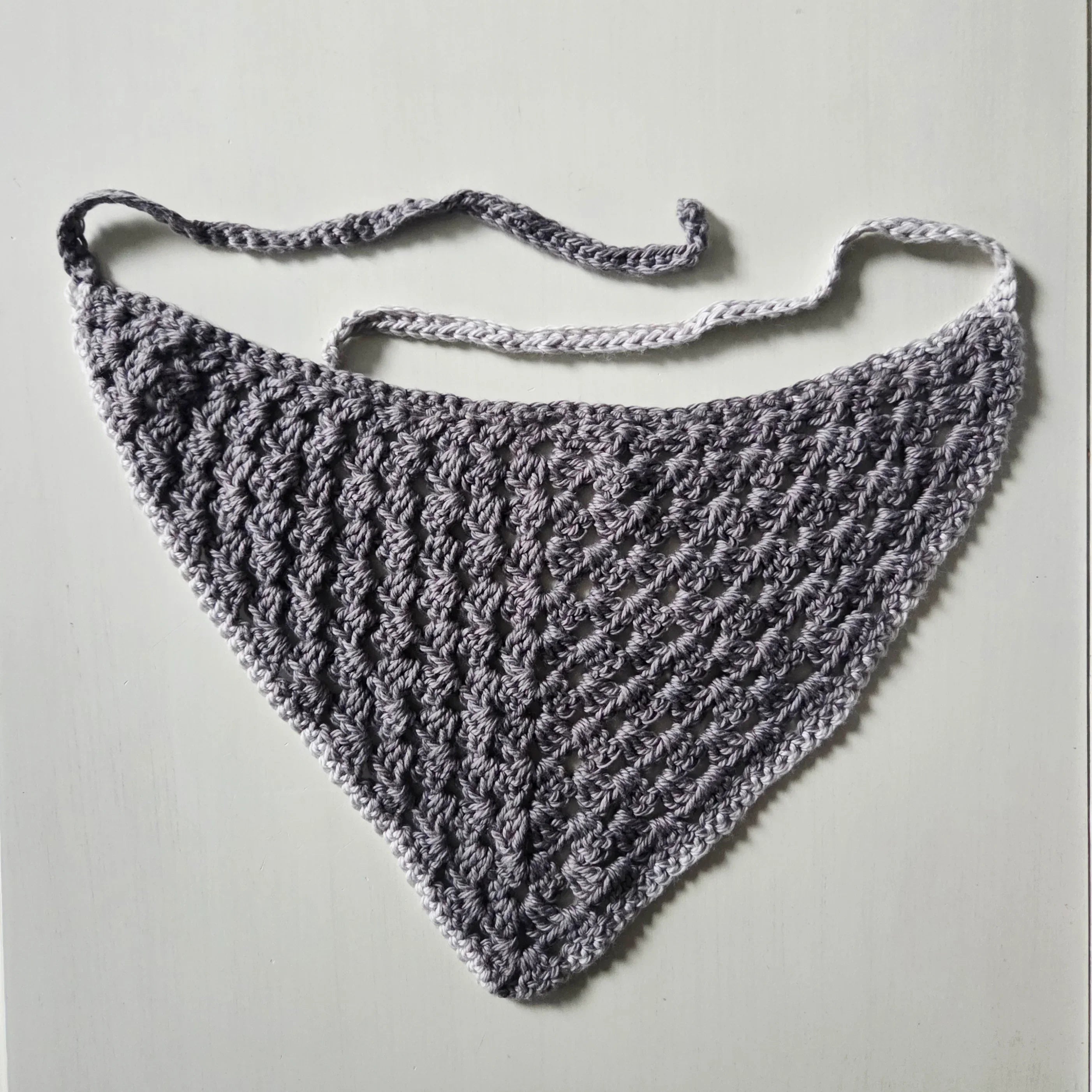 Handmade gray crochet triangle scarf with delicate lace pattern and adjustable ties